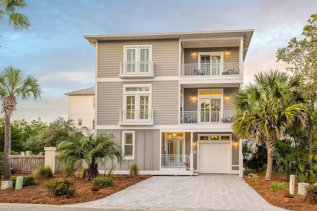 beach home with a balcony and a garage