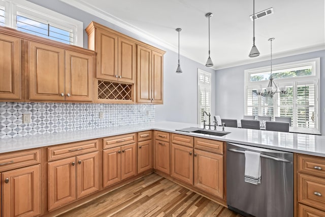 kitchen with a chandelier, dishwasher, pendant lighting, and sink