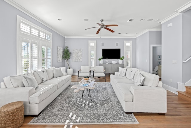 living room featuring ceiling fan, hardwood / wood-style floors, and ornamental molding