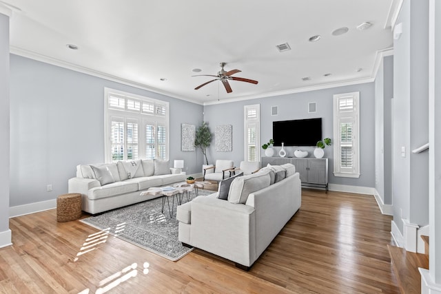 living room with ornamental molding, ceiling fan, plenty of natural light, and hardwood / wood-style flooring