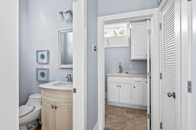 bathroom featuring vanity and toilet