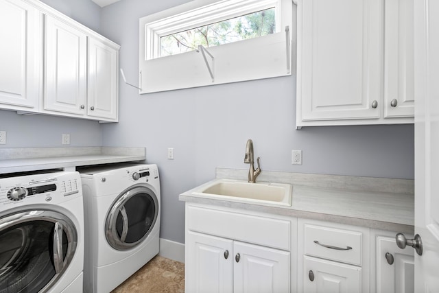 laundry area featuring sink, cabinets, and independent washer and dryer