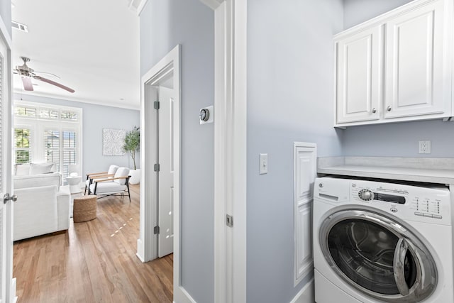 laundry area featuring cabinets, light wood-type flooring, crown molding, ceiling fan, and washer / dryer