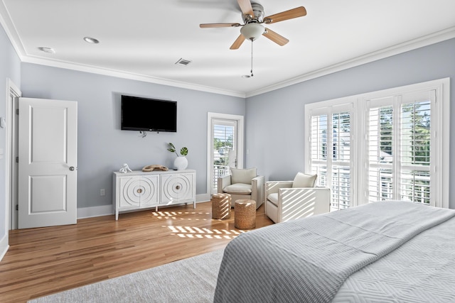 bedroom with ornamental molding, ceiling fan, and hardwood / wood-style floors