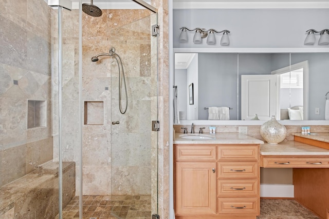 bathroom featuring a shower with door and vanity