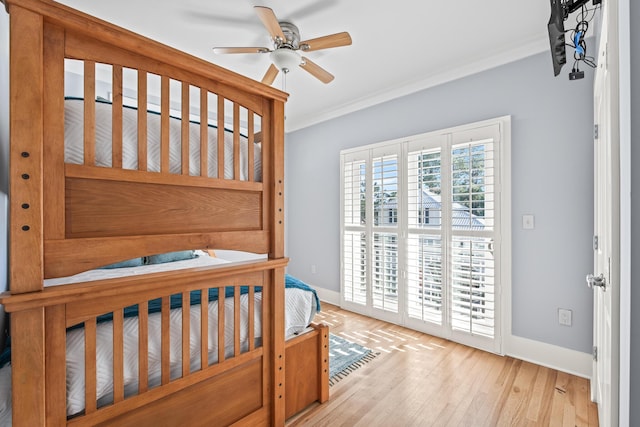 bedroom featuring ornamental molding, ceiling fan, and light hardwood / wood-style floors