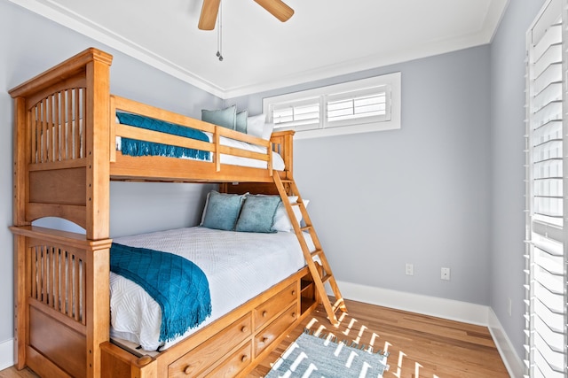 bedroom featuring ornamental molding, ceiling fan, and wood-type flooring