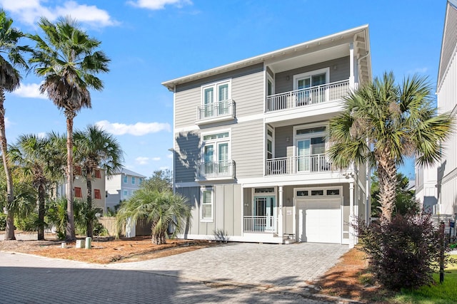 raised beach house featuring a garage