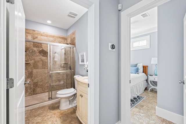 bathroom with toilet, a shower with door, and vanity