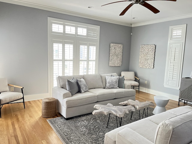 living room with light wood-type flooring, ceiling fan, and ornamental molding