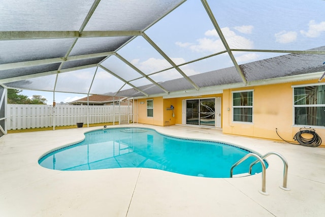 view of pool featuring glass enclosure and a patio