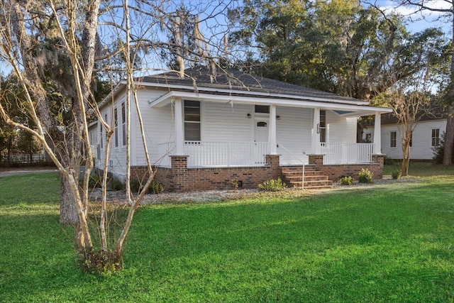 bungalow-style home featuring covered porch and a front lawn