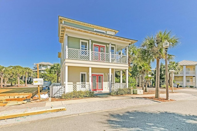 raised beach house with french doors and a balcony