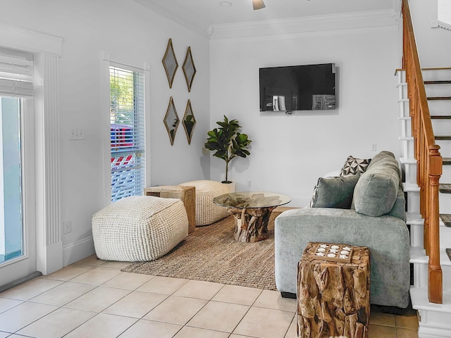 living area with crown molding and light tile patterned floors