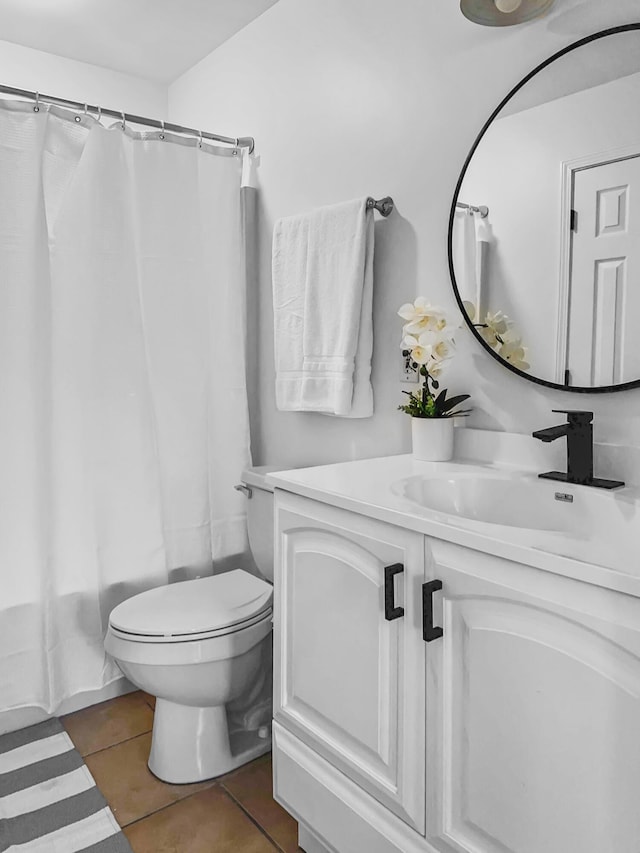 full bathroom with toilet, tile patterned flooring, shower / tub combo with curtain, and vanity