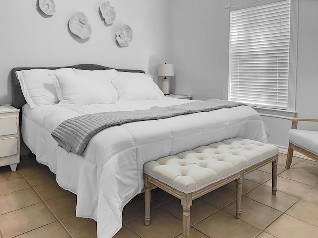 bedroom with light tile patterned floors