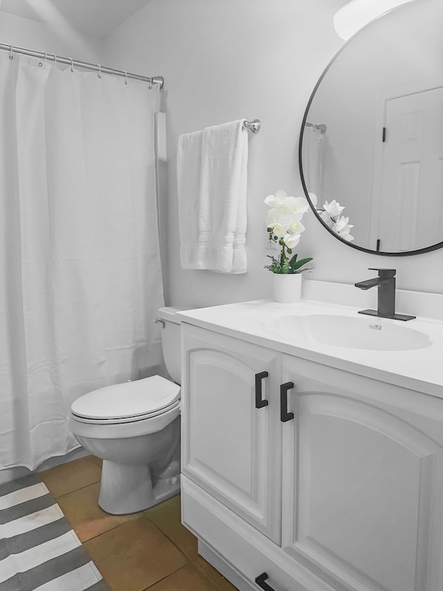 bathroom with vanity, tile patterned floors, and toilet