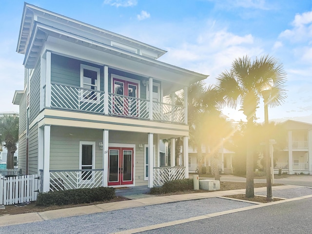 view of front of house with french doors and a balcony