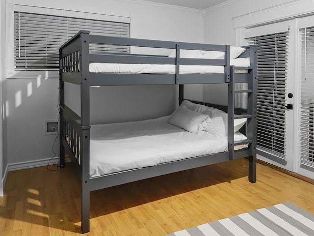 bedroom featuring hardwood / wood-style floors and crown molding