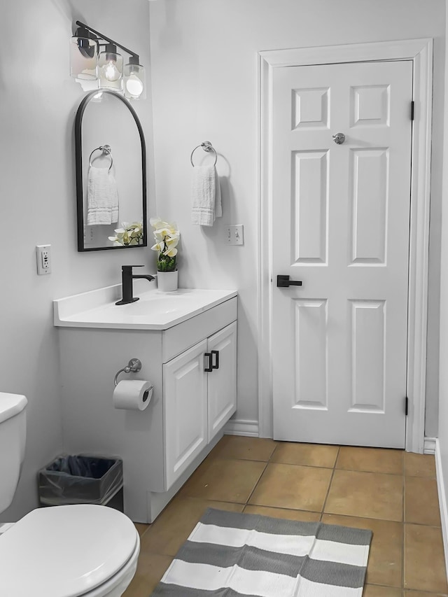 bathroom featuring toilet, vanity, and tile patterned floors