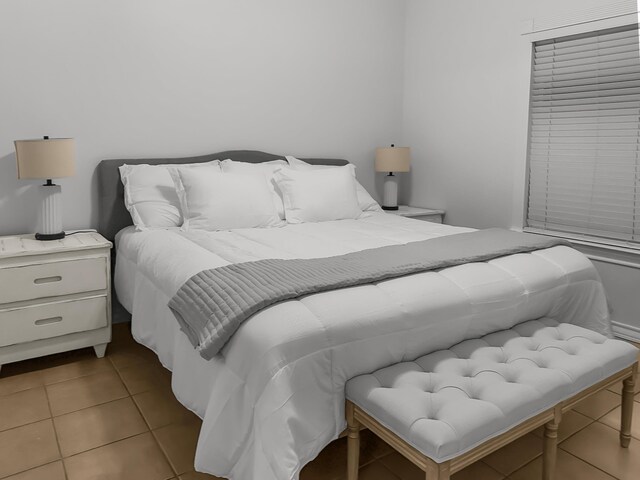 bedroom with light tile patterned floors