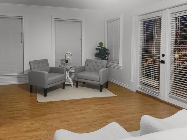 sitting room featuring ornamental molding and light hardwood / wood-style flooring