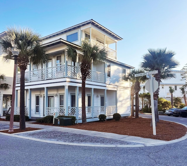 view of front of property featuring a porch and a balcony