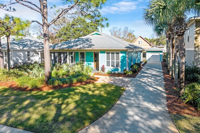 view of front of house with a front lawn, an outdoor structure, and a garage