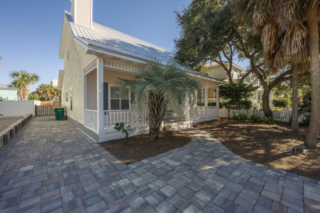 view of side of home with covered porch