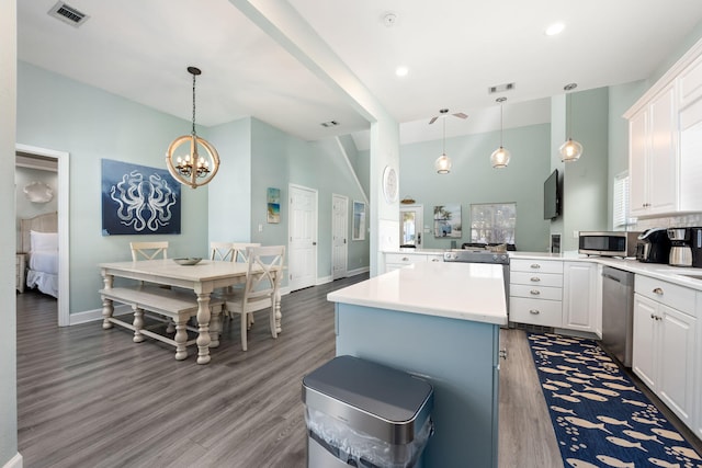 kitchen with white cabinetry, pendant lighting, and stainless steel appliances