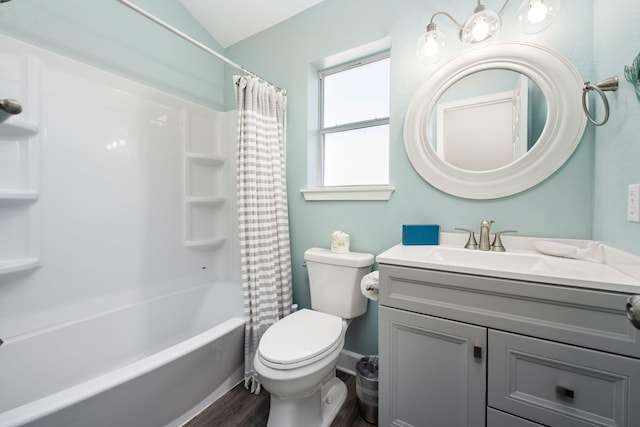 full bathroom featuring lofted ceiling, hardwood / wood-style flooring, vanity, shower / tub combo, and toilet