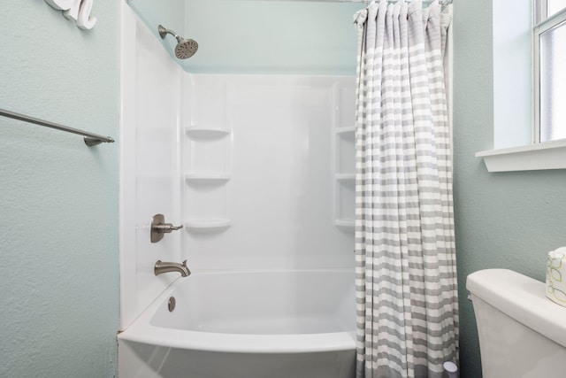 bathroom with shower / bath combination with curtain and toilet