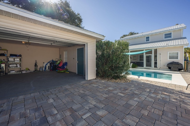 view of pool with a patio and area for grilling