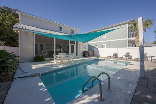 view of swimming pool featuring area for grilling and a patio