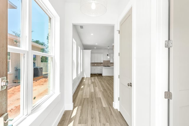 hall with light hardwood / wood-style floors