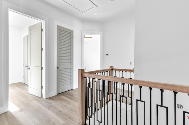 corridor with light hardwood / wood-style floors