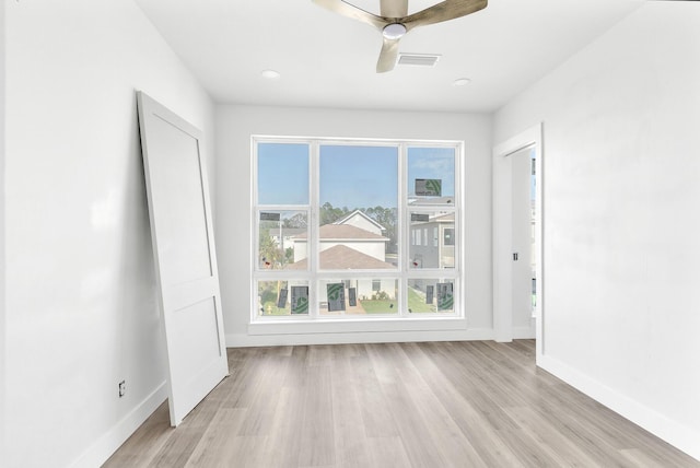 spare room with ceiling fan and light hardwood / wood-style flooring