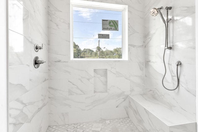 bathroom featuring a tile shower