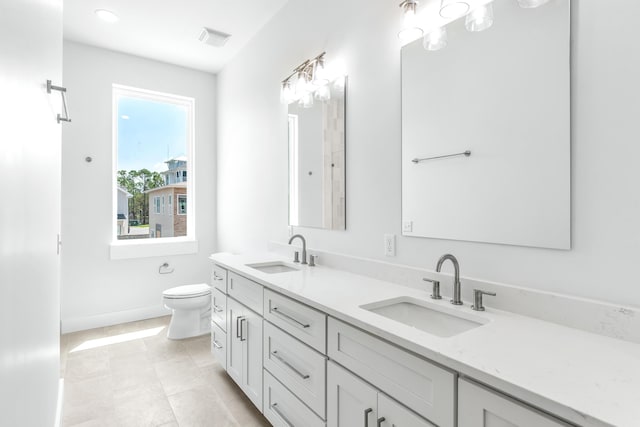 bathroom with toilet and vanity