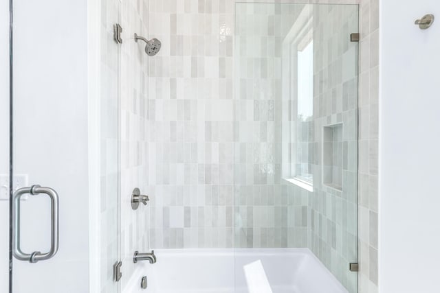 bathroom featuring shower / bath combination with glass door