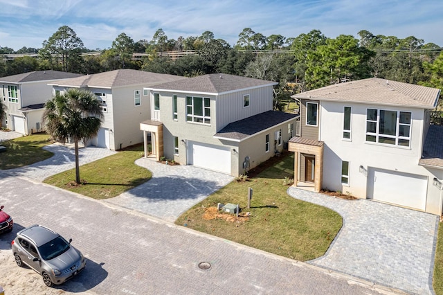 view of front of property with a front lawn and a garage