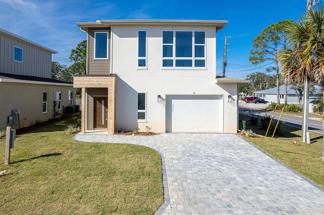 view of front facade featuring a front yard, a garage, and central AC unit