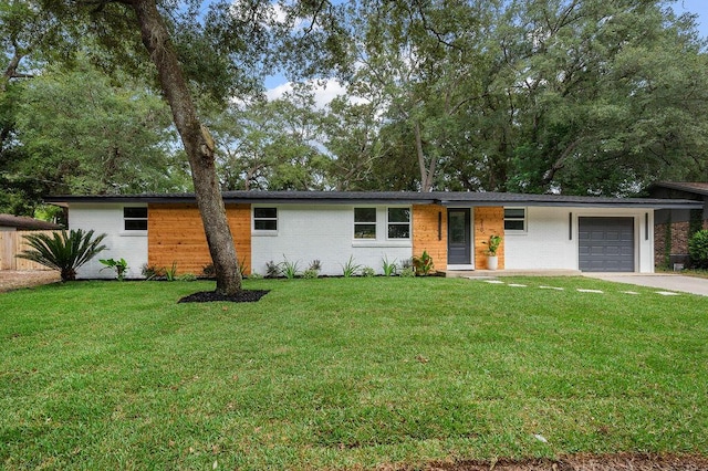 single story home featuring a front yard and a garage