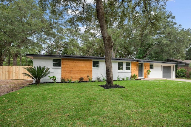 single story home with a front yard and a garage