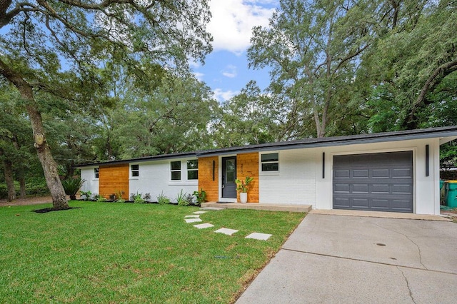 ranch-style home with a front lawn and a garage