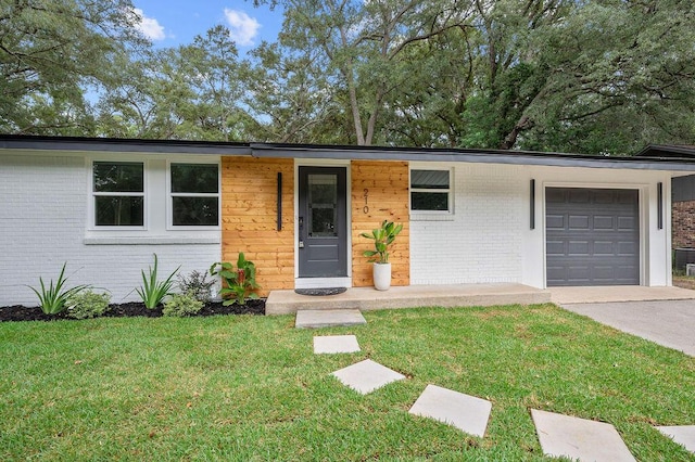 ranch-style home with a garage and a front lawn