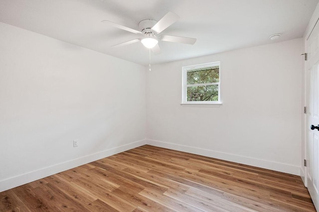 empty room with ceiling fan and light hardwood / wood-style flooring