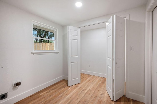 unfurnished bedroom featuring a closet and light hardwood / wood-style floors