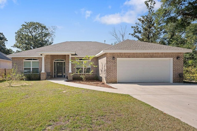 view of front of home featuring a front yard and a garage