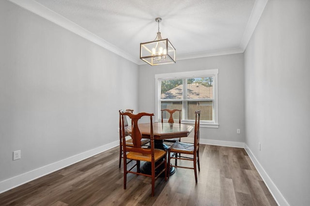 dining area featuring a chandelier, crown molding, and dark hardwood / wood-style floors